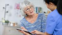 Elderly patient talking to a nurse
